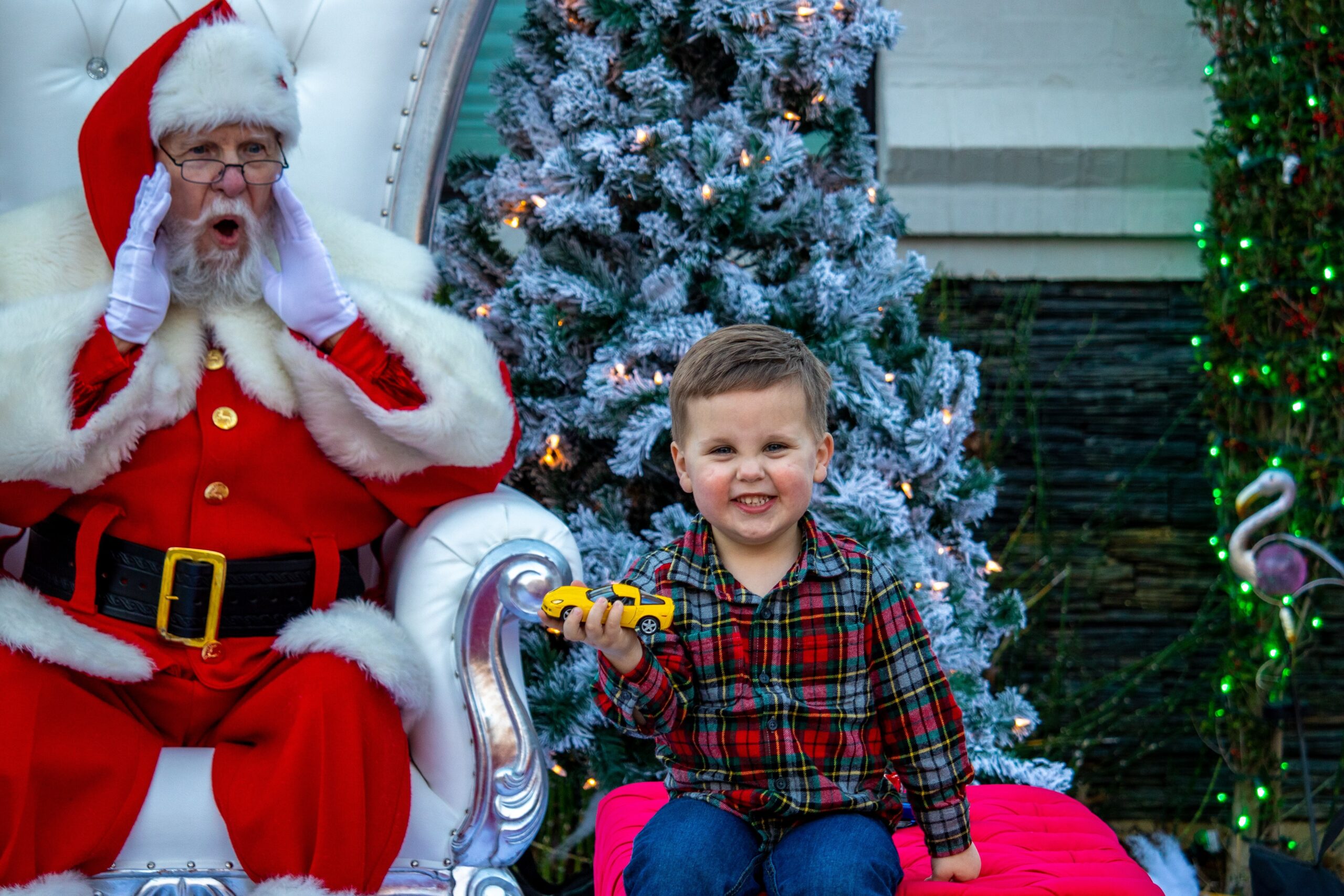 Santa sitting with child.